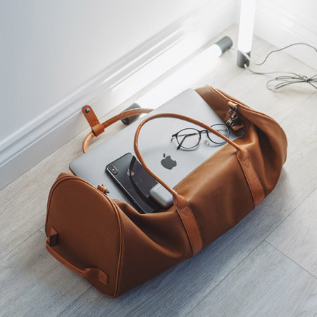 mens brown bag with iphone mac